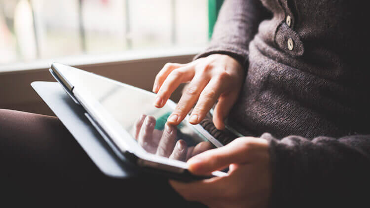 Close up of person holding a tablet device